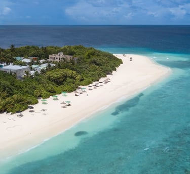 a beach with a white sand and blue sky