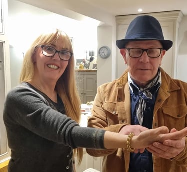 Rob Hamilton reading the palm of a female client