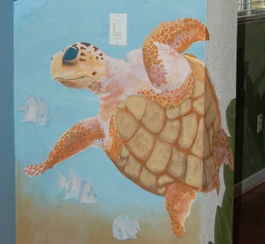 Interior wall mural of a sea turtle swimming with fish in six feet of water near St Pete Beach, FL