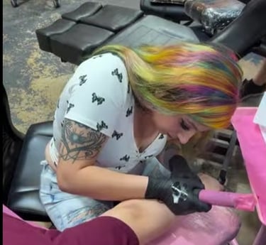 a woman getting tattoo by talented artist that can customize any vision of art for someone