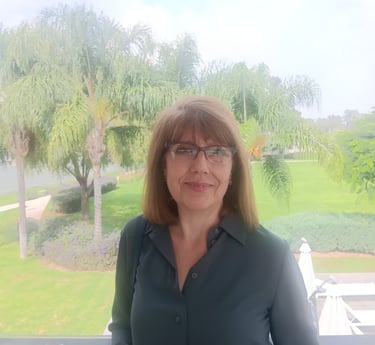 a woman in a blue shirt and glasses