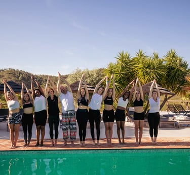a group of people standing around a pool