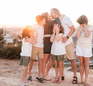 a family of four children and their parents in a family photo