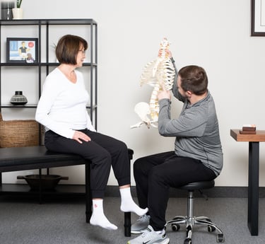 Osteopathic practitioner educating the patient on the spine