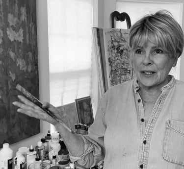 a woman in a denim jacket and jeans standing in front of a painting