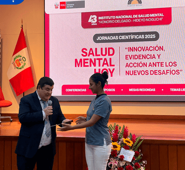 a man and woman standing in front of a screen