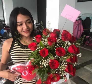 a woman holding a bouquet of roses in her hands