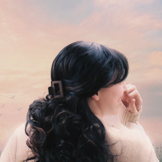 a woman with long hair and a hair clip in her hair