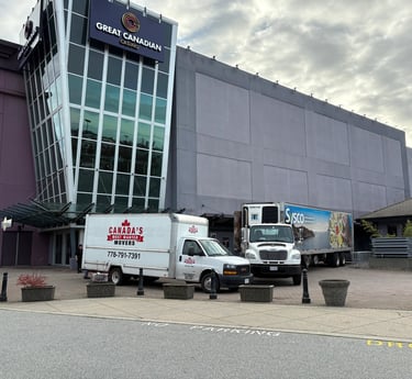 Canada’s Most Wanted Movers trucks parked at Great Canadian Casino Vancouver for a commercial moving job.
