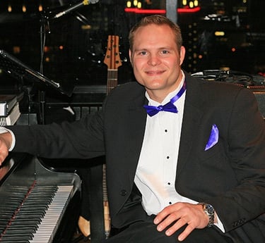 Peter Schroeder playing piano at Vancouver's revolving restaurant, Cloud Nine, for a New Year's Eve 