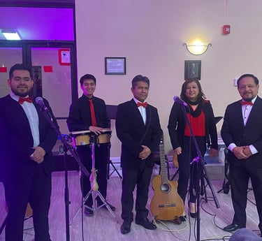 Live music band group taking a photo with guitars and bongos in the background.