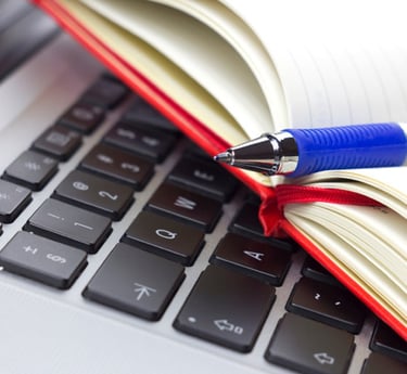 a pen and a pen on a laptop computer