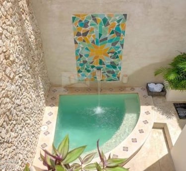 a pool with a fountain and a fountain
