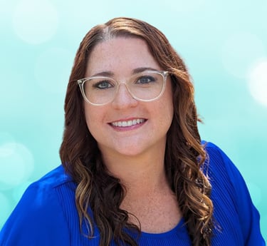 a woman in a blue shirt and glasses