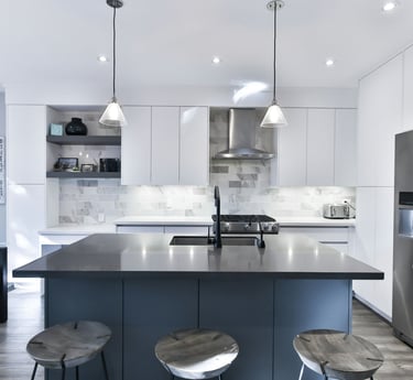 a kitchen with a stainless steel refrigerator and a large island