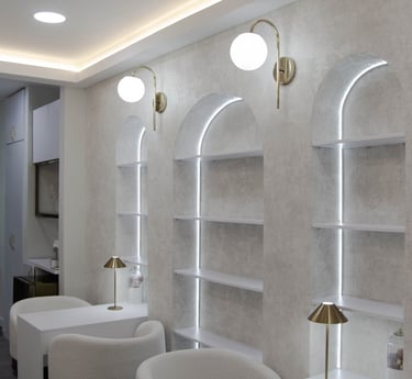 Área de lavacabezas con nichos decorativos y luz tenue.