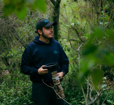 a man in a black hat and a camera