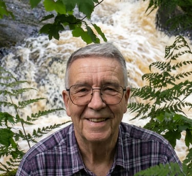 man stood above the Strid a fast flowing pint of the river Wharf at Bolto abbey woods. 