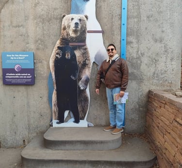 Luis standing next to a trio of bear cutoffs to compare his height.