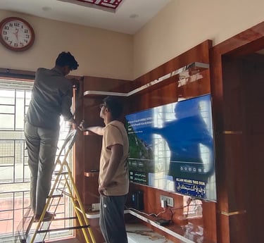 A technician fitting a velcro mosquito net on a sunny Bangalore balcony.