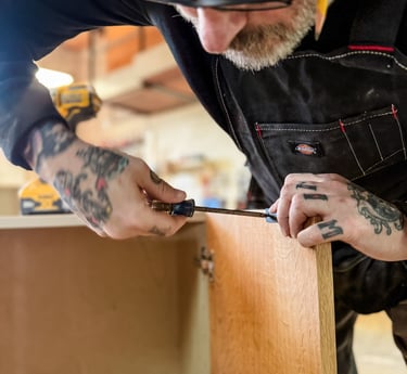 Master craftsman creating custom woodworking project in Detroit woodship.