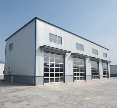 A painter carefully applying a fresh coat of vibrant paint to a modern warehouse exterior under bright daylight.