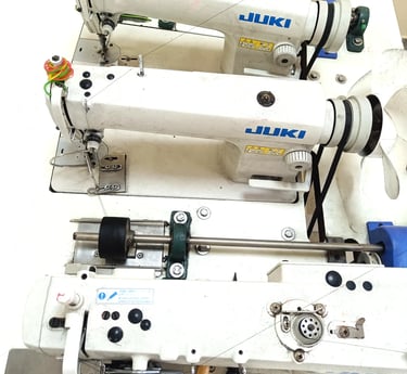 Triple head industrial human hair sewing machine used for manufacturing human hair wefts at Tanori Hair LLP in India.