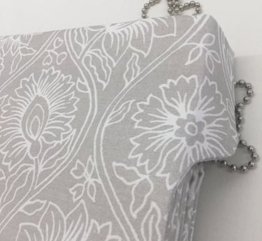 A roman blind with side flaps to cover the headrail. attention to detail