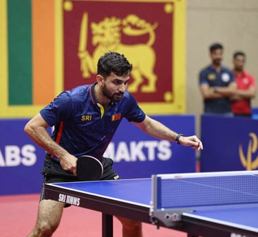 A lively group of Sri Lankan table tennis players and coaches sharing a moment of teamwork and celebration.