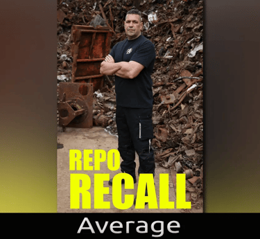 A man standing in front of scrap metal 