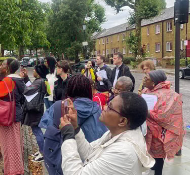 a group of people standing at the site of Kelso Cochrane's housr.