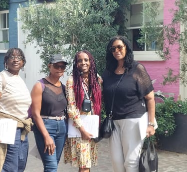 a group of people standing in front of the Love Actually house in Notting Hill