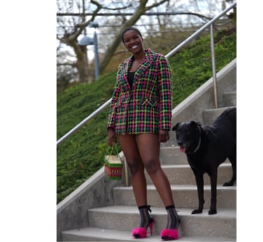 Woman posing with a black dog 