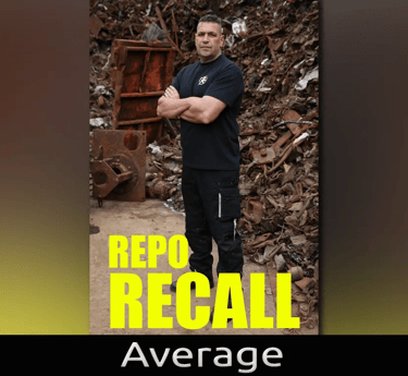 A man standing in front of scrap metal 