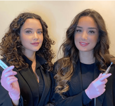 two women in suits and gloves holding toothbrushes