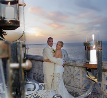 newly weds smiling in front of sunset