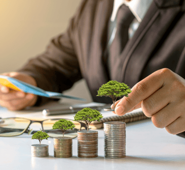 a man in a suit and tie is putting coins into a stack of coins