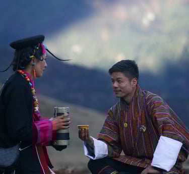 Layap-women-in-Bhutan-with-a-traditional-gesture-of-welcoming-a-guest-serving-local-wine-ara