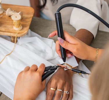 a woman is applying permanent jewelry bracelet 