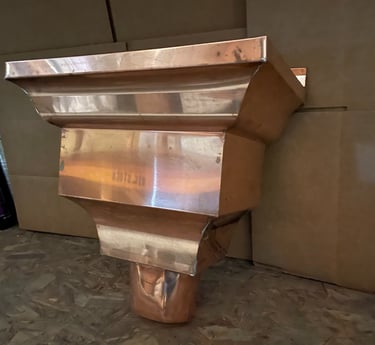 Seamless copper gutters installed on residential home exterior