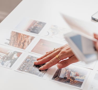 a person holding personal photographs in their hand doing a choice