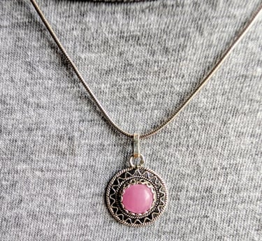 Elegant sterling silver pendant with a round pink Macedonian ruby on a silver chain necklace.