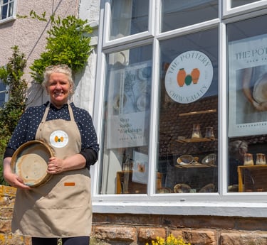 a woman in a apron and aprons holding a tray with a tray of food