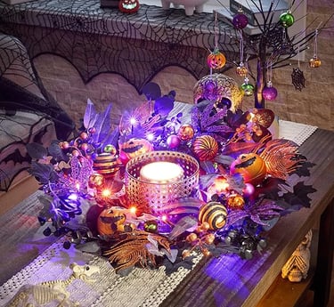 Halloween centerpiece featuring a glowing candle surrounded by purple and orange lights, artificial 