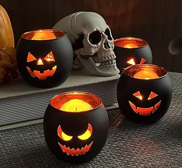 Set of black Halloween candle holders with glowing jack-o’-lantern faces, displayed beside a realist