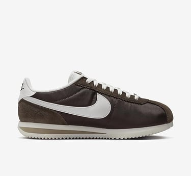 Classic Nike Cortez women’s sneaker in dark brown and white with retro running design, perfect for c