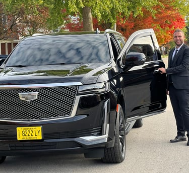 A chauffeur standing next to an SUV