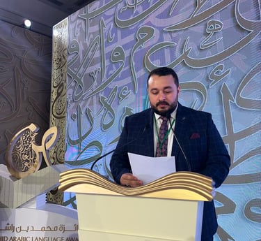 a man in a suit and tie standing at a podium