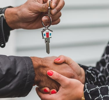 a man and woman shaking hands with keys