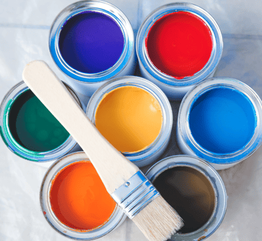 a paintbrush and paints with different types and colors